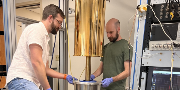 Jordan Russell and Jonah Hoffman installing the 14T magnet on the shared dilution refrigerator