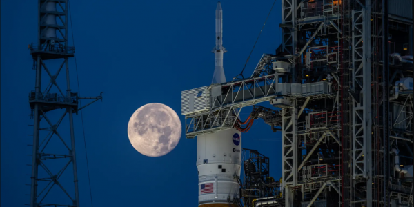 A full Moon in view on June 14, 2022 behind the Space Launch System and Orion spacecraft atop the mobile launcher at Launch Complex 39B at NASA’s Kennedy Space Center in Florida. Credits: NASA/Ben Smegelsky