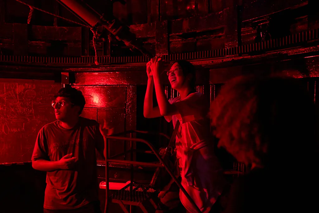 Students in the Crow Observatory looking through the telescope